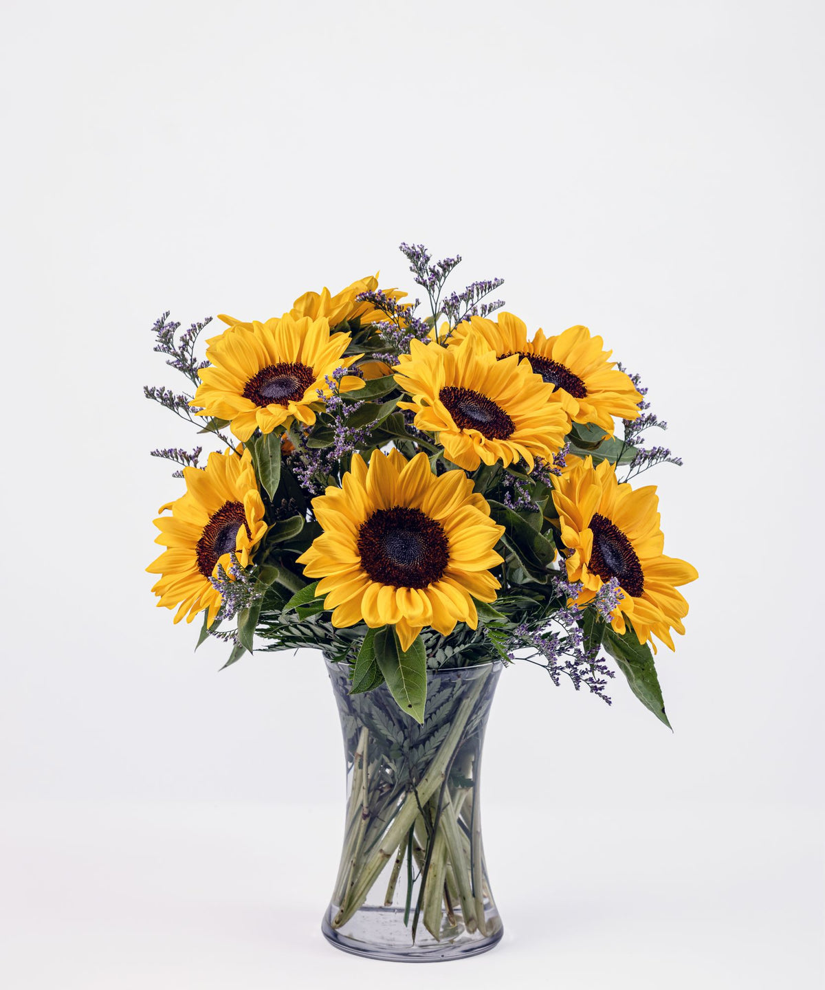 Rustic sunflower arrangement in a clear glass vase with bright yellow blooms and country-inspired charm