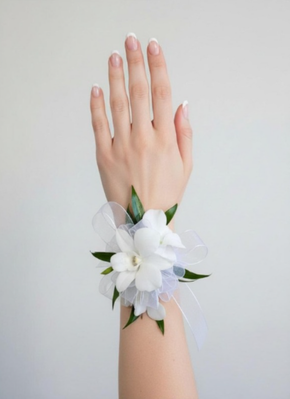 Dendrobium orchid corsage with delicate blooms, greenery, and matching ribbon