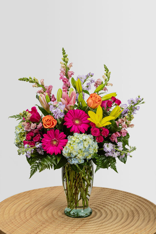The Erin - Colorful Spring inspired arrangement consisting of lilies, gerbera daisies, hydrangea, roses.